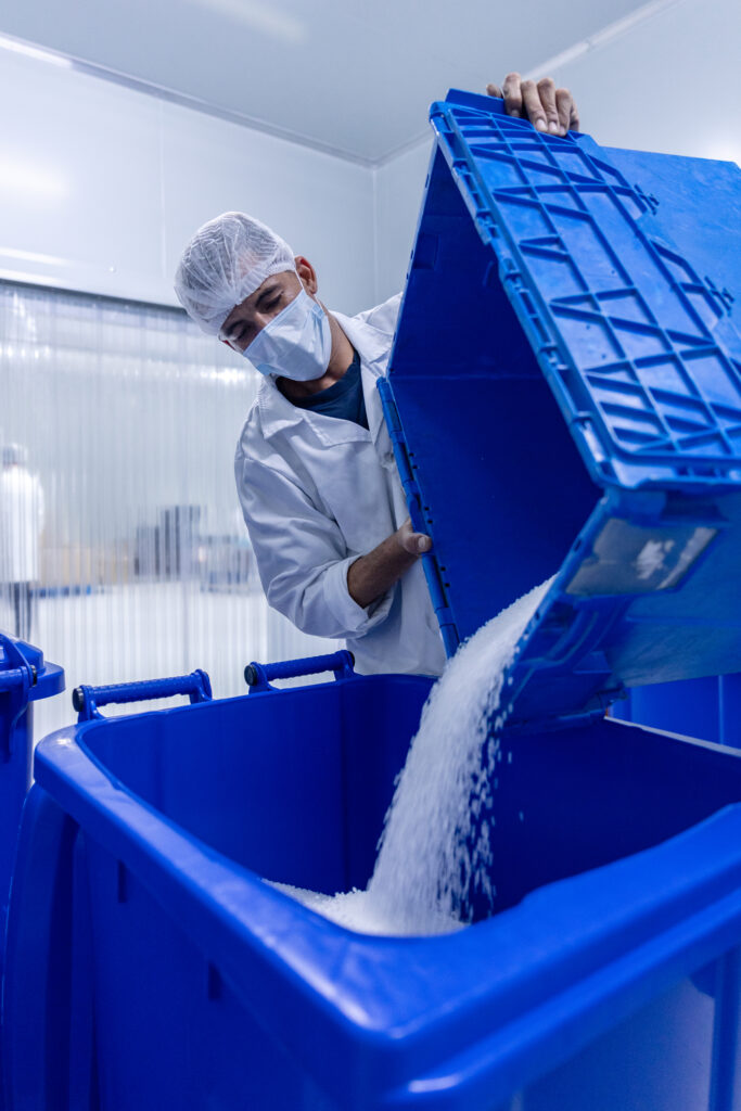 employee storing plastic parts of a products